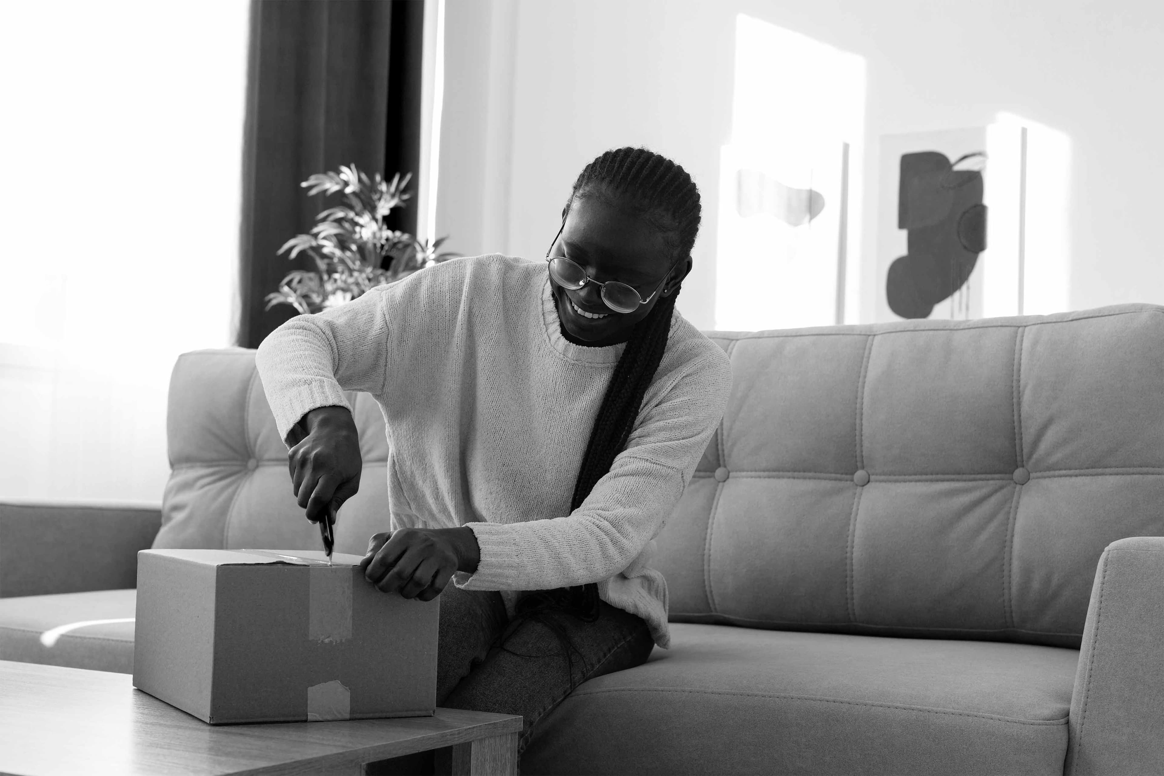 Person happily opening a delivery package